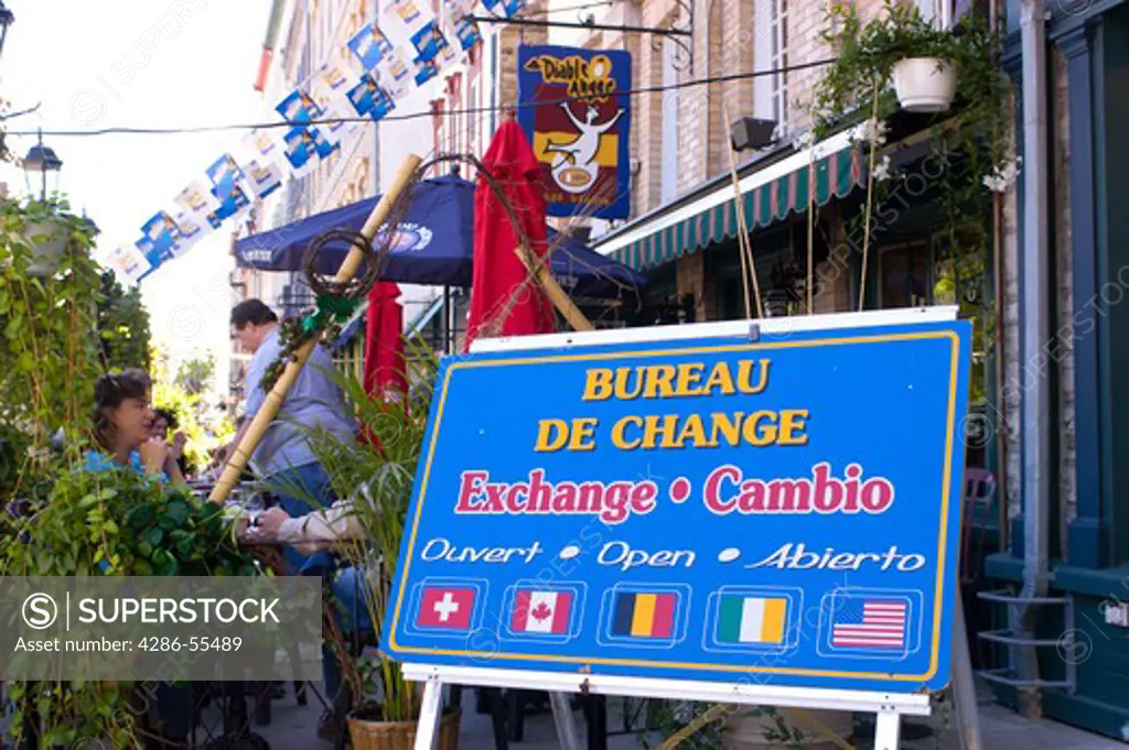 QUEBEC CITY, QUEBEC, CANADA - Trilingual sign in french, english and spanish for money exchange business.
