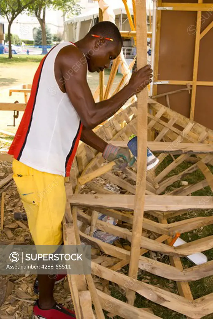 WASHINGTON, DC, USA - Boat builder Jean Gesner Elian, from Luly on the southern coast of Haiti, constructs boat by hand, during the 2004 Smithsonian Folklife Festival.