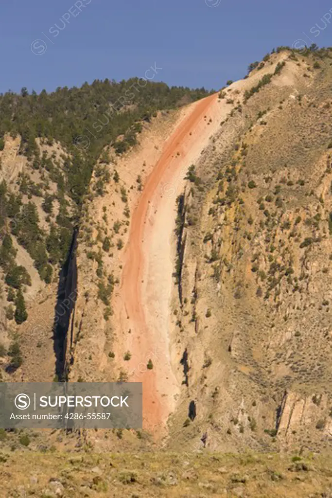 GARDINER, MONTANA, USA - Devil's Slide, Paradise Valley. The rock layers were raised and tilted by faulting. Softer shales eroding faster than hard sandstones cause the red, 200-million-year-old Chugwater mudstone to appear as a slide.