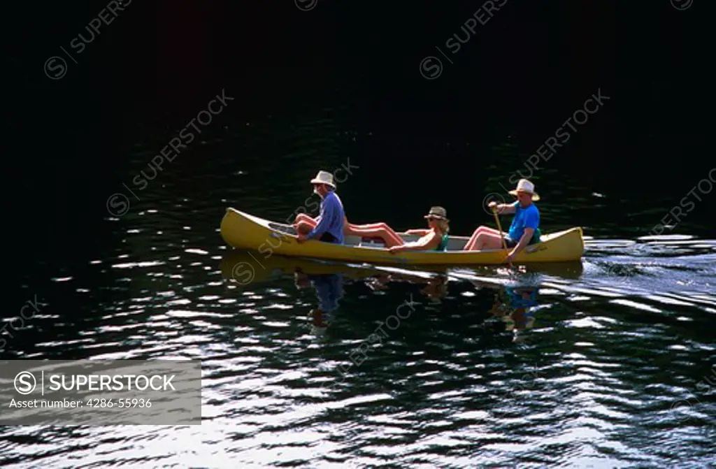 Family canoeing in Loch Lomond Resevoir, Santa Cruz, California.