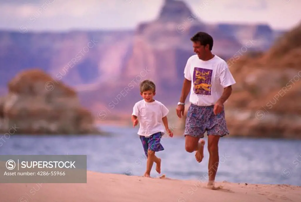 Father playing with young son, Lake Powell, UT