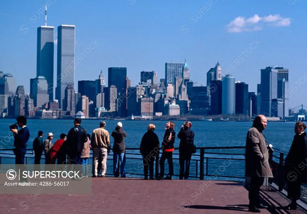 Tourists view the New York City skyline from across the East River, New York.