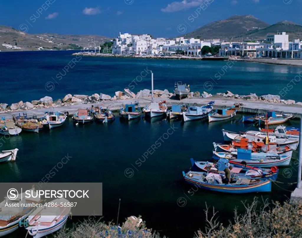Parikia town and small fishing boats in harbor, Paros island, Greece. 