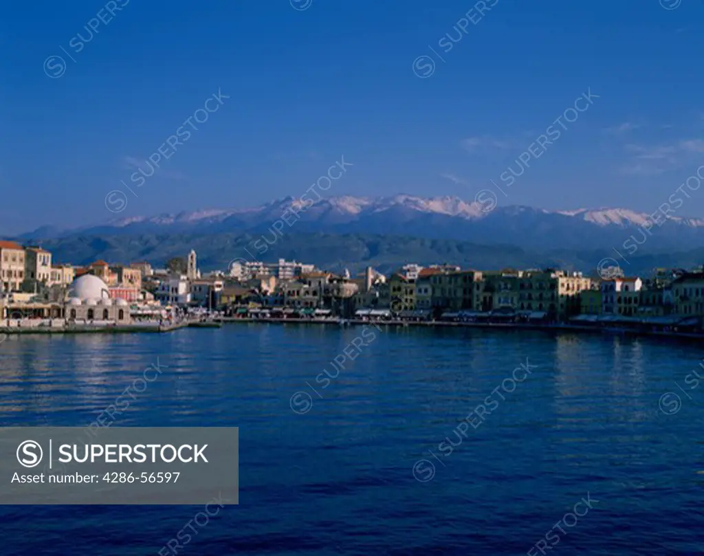 Chania harbor and snow-capped White Mountains (Lefka Ori), western Crete, Greece.