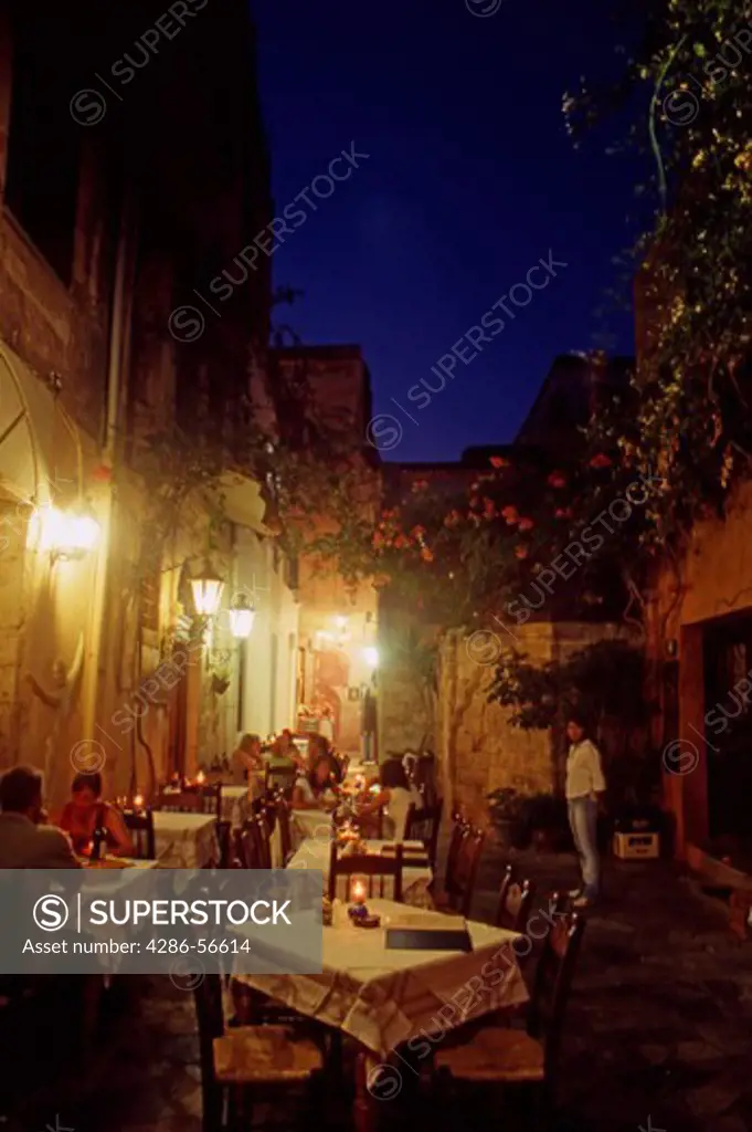 Typical Venetian Alleyway and Restaurants at night in Chania Old Town. Western Crete. Greece.