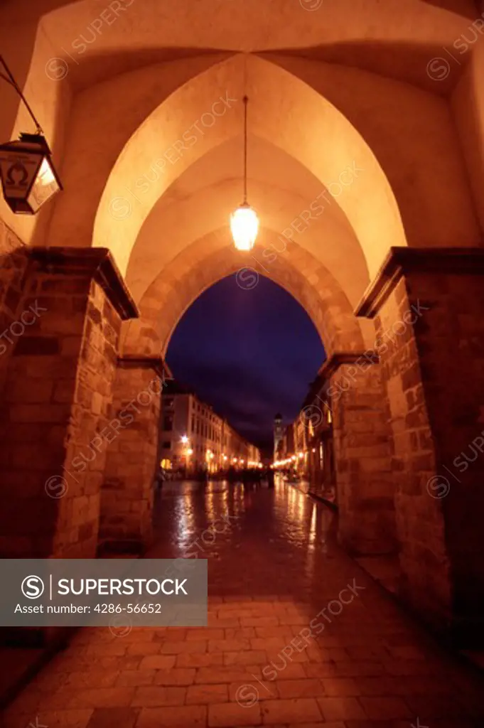 Illuminated Gateway into Luza Square and the the Stradun, Placa, Dubrovnik Old City, Croatia.