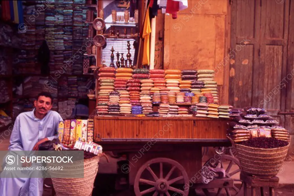 Egypt. Luxor. Herb and tea trader sat outside his shop.