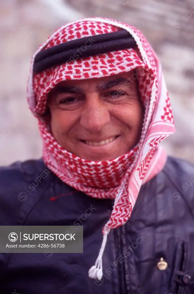  Portrait of Steve, an official Tour Guide at the Roman Amphitheater in Amman, wearing the traditional Jordanian Keffiyeh head cloth, Jordan, The Middle East.