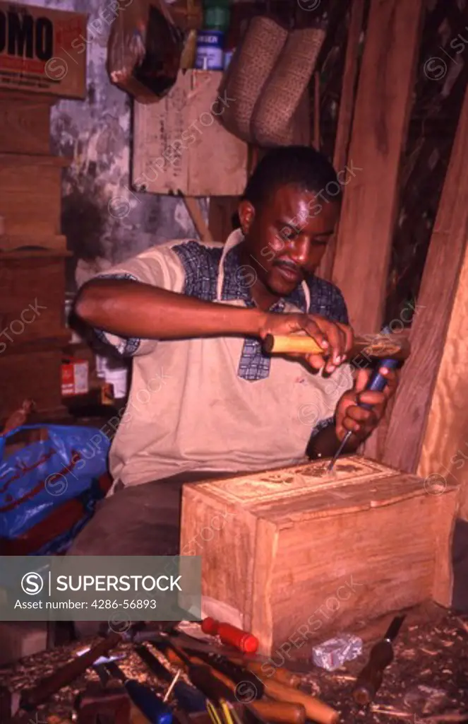 Wood Carver working in his workshop at the Arab Fort. Stone Town. Zanzibar.