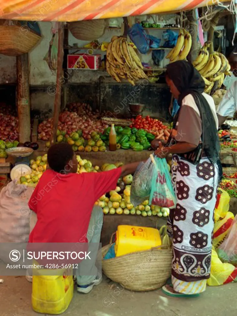  Local woman buying food in Stone Town Market. Zanzibar. Tanzania.