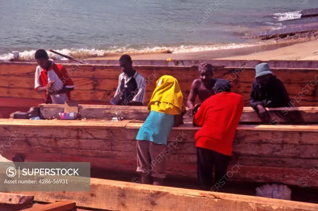 A group of Zanzibari men constructing Dhow boats. Stone Town. Zanzibar. Tanzania.