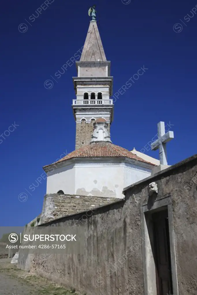 Slovenia. Piran. The Exterior of Saint George Cathedral. Bell Tower and Cemetery Entrance