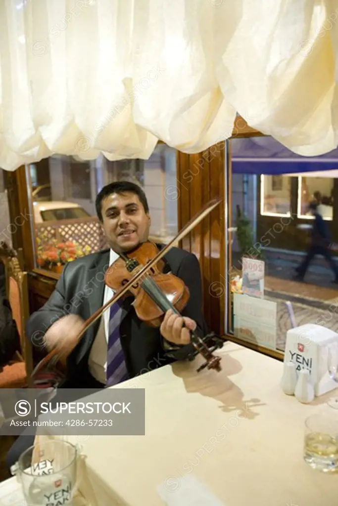 Istanbul, Turkey. Saturday night entertainment at Fener Fish Restaurant. A musician playing his Violin. Property Released