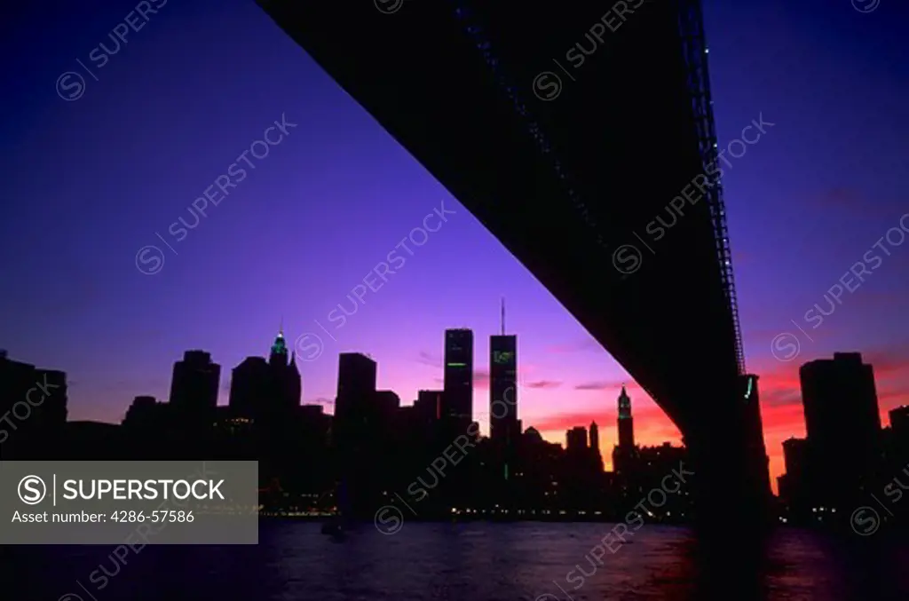 Manhattan skyline at sunset as seen from Brooklyn with the World Trade Center Building and the Brooklyn Bridge, New York City, New York.