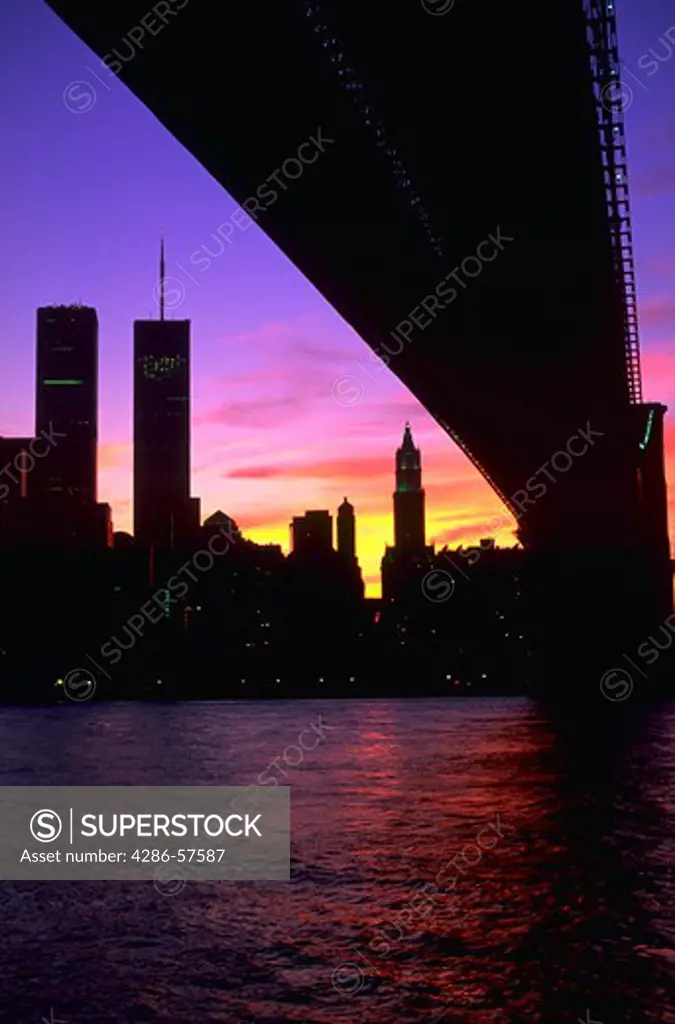 Manhattan skyline at sunset as seen from Brooklyn with the World Trade Center Building and the Brooklyn Bridge, New York City, New York.