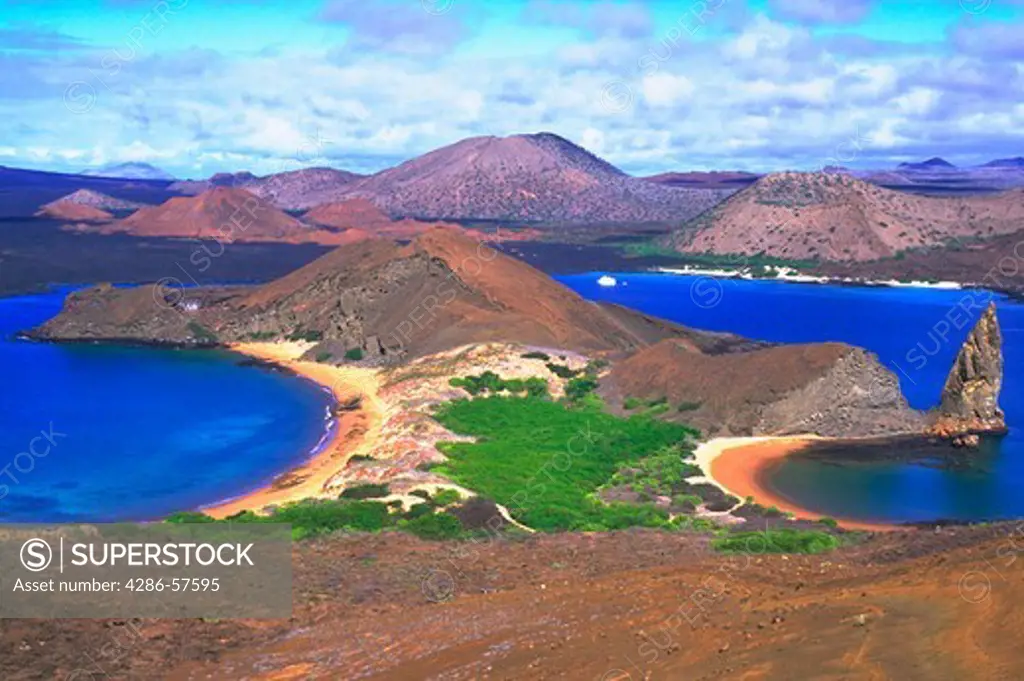 View of blue water surrounding Pinnacle Rock, a volcanic rock , on Bartolome Island, Galapagos, Ecuador.