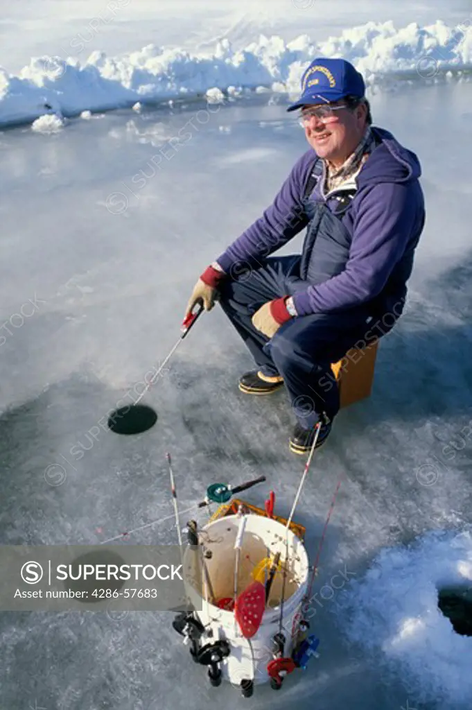 Older man ice fishing at Rock Cut State Park in Rockford, IL.