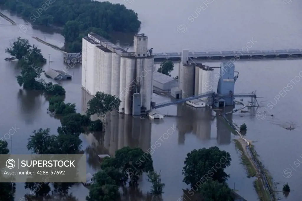 Aerial view of a grain elevator that is surrounded by water due to an overflowing Mississippi River in Meyer, IL.