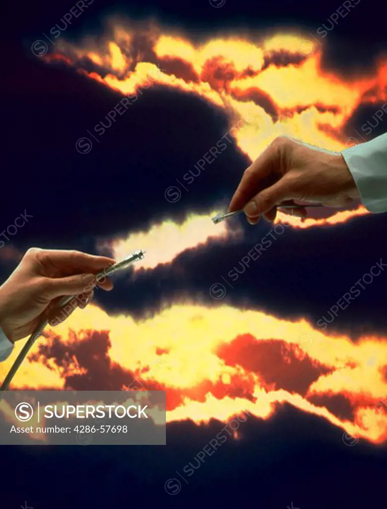 Two mens hands holding different networking connections and meeting against dark clouds.  One hand is holding an ethernet phone cable and the other hand is holding a coaxial network cable.