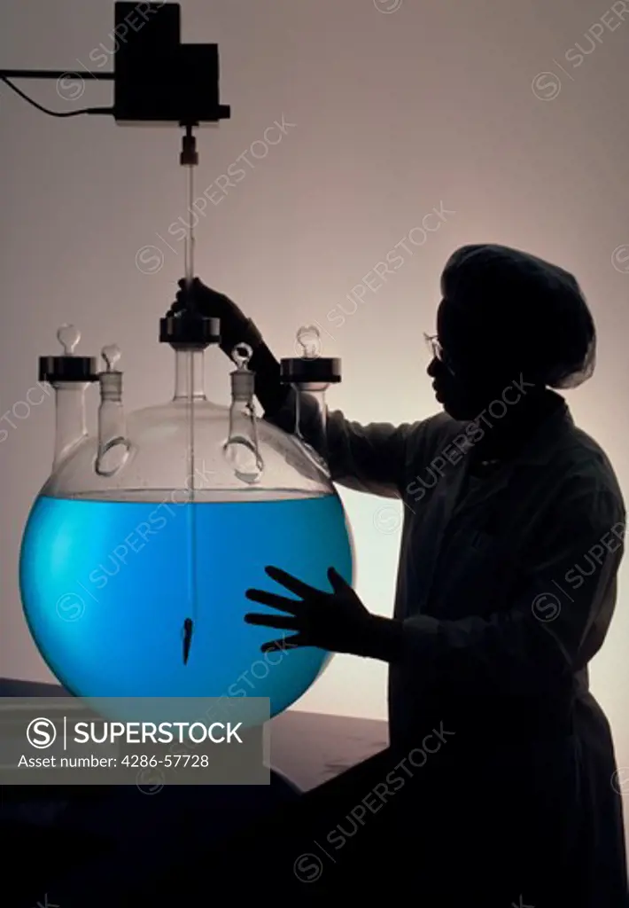 A lab technician performs a test on a chemical in a biotechnology company.