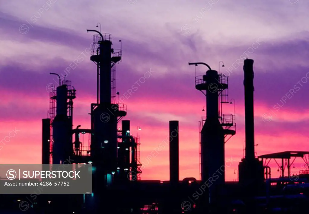 Petroleum oil refinery at dusk with a purplish, pink sky in the background taken in Los Angeles, CA.