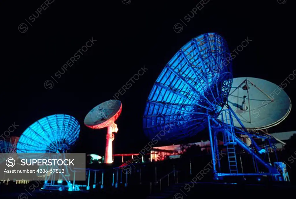 Night time images of large, communication microwave dishes.