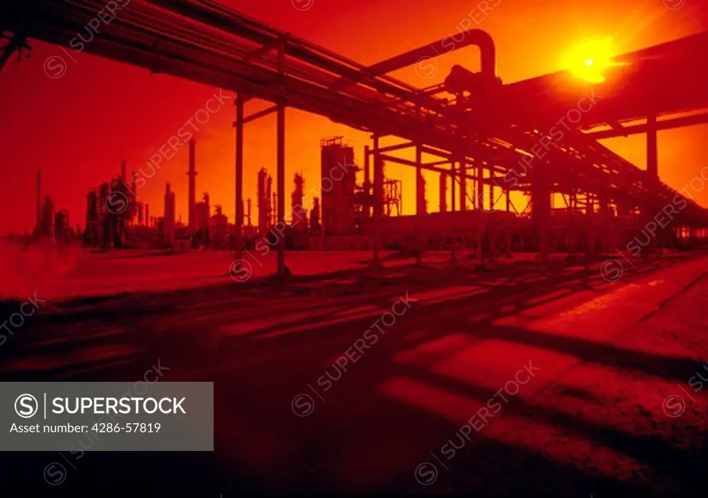 The sun sets on a petroleum refinery plant in New Jersey.