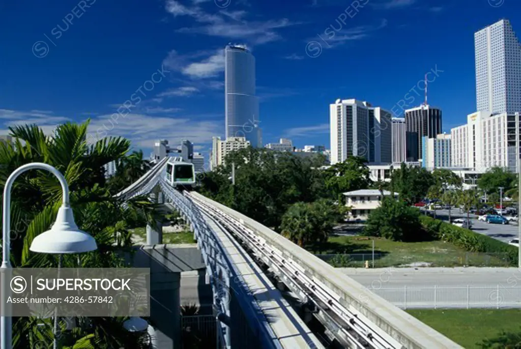 A Metromover car, an automated peoplemover, moves along an elevated track near downtown Miami, Florida.