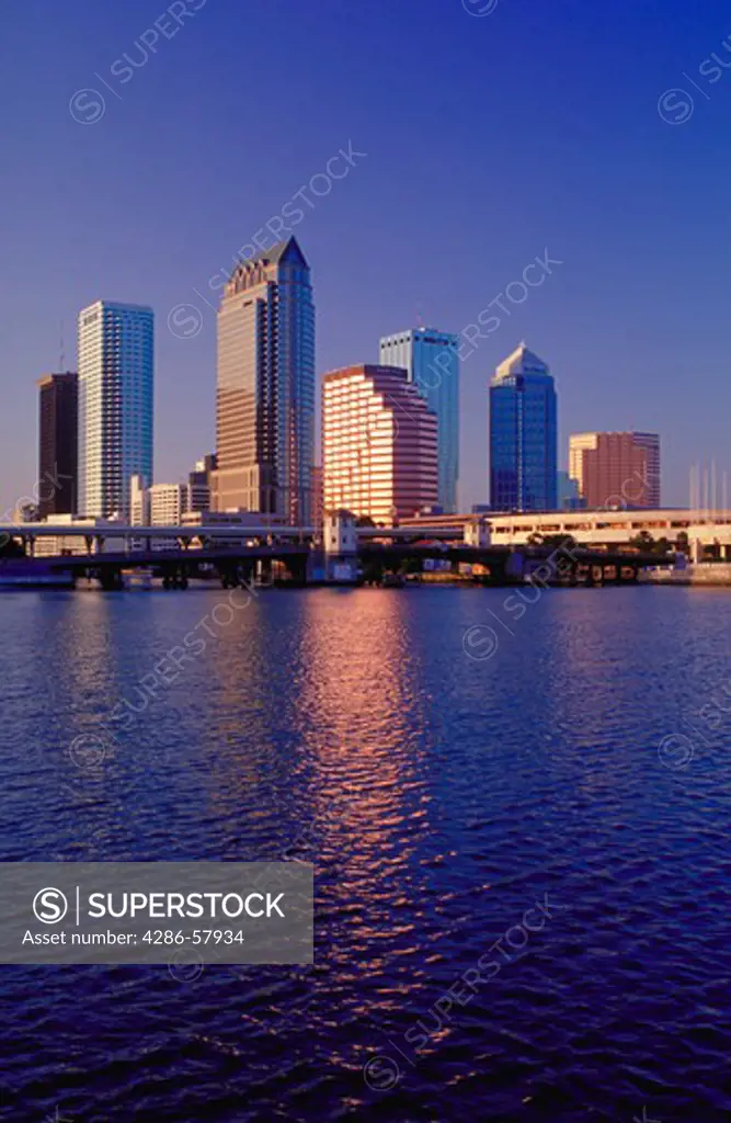 View at night, looking due North after sunset of the illuminated skyscrapers along the downtown Tampa Bay, Florida skyline.  The Tampa convention center can be seen at the far right.