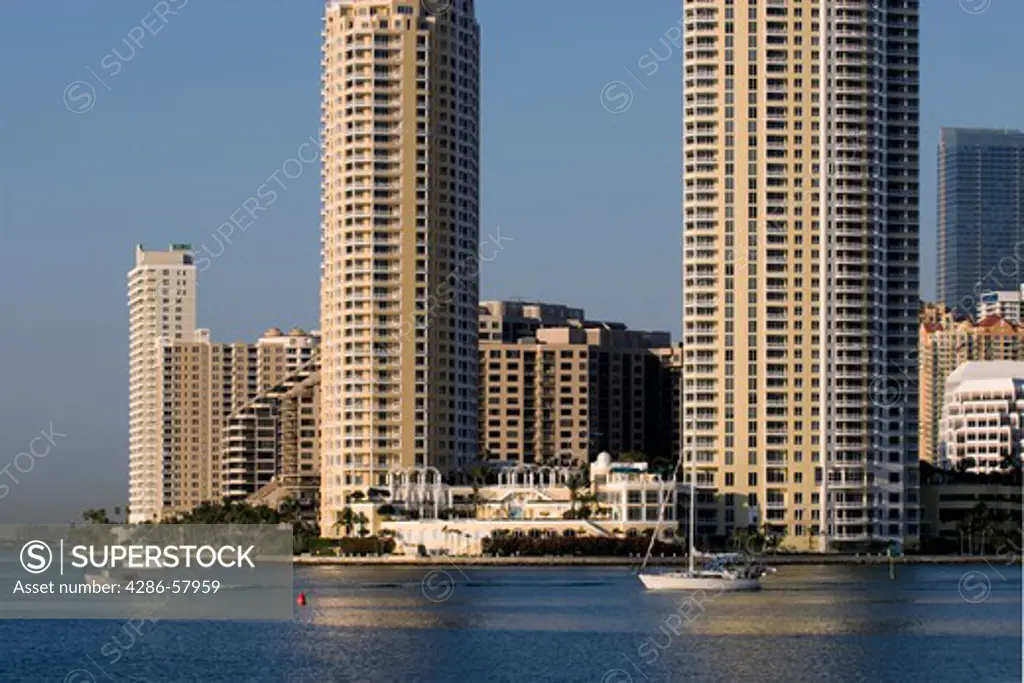 Pleasure boasts pass under condominium and business towers that line Biscayne Bay, Miami, Florida.