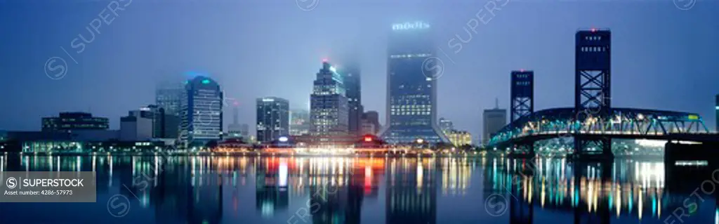 Downtown Jacksonville, Florida, viewed through fog at dawn, over St. Johns River.