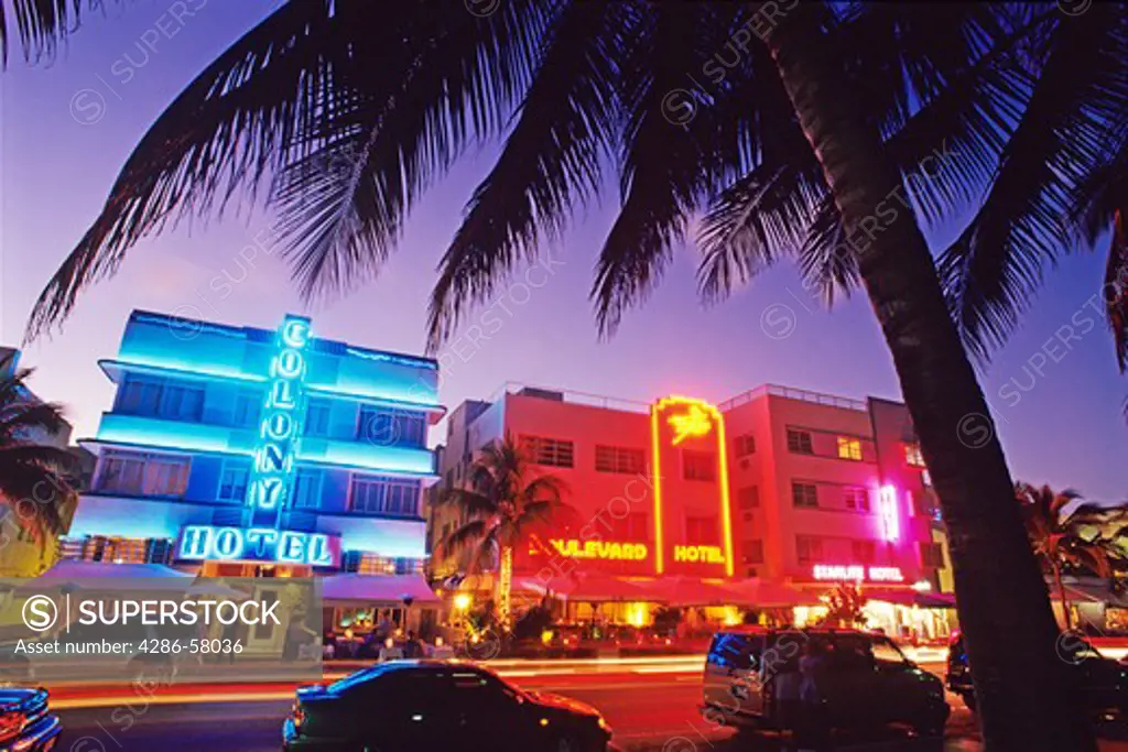 Glowing neon accents art deco era hotels along Ocean Drive at twilight, Miami Beach, Florida