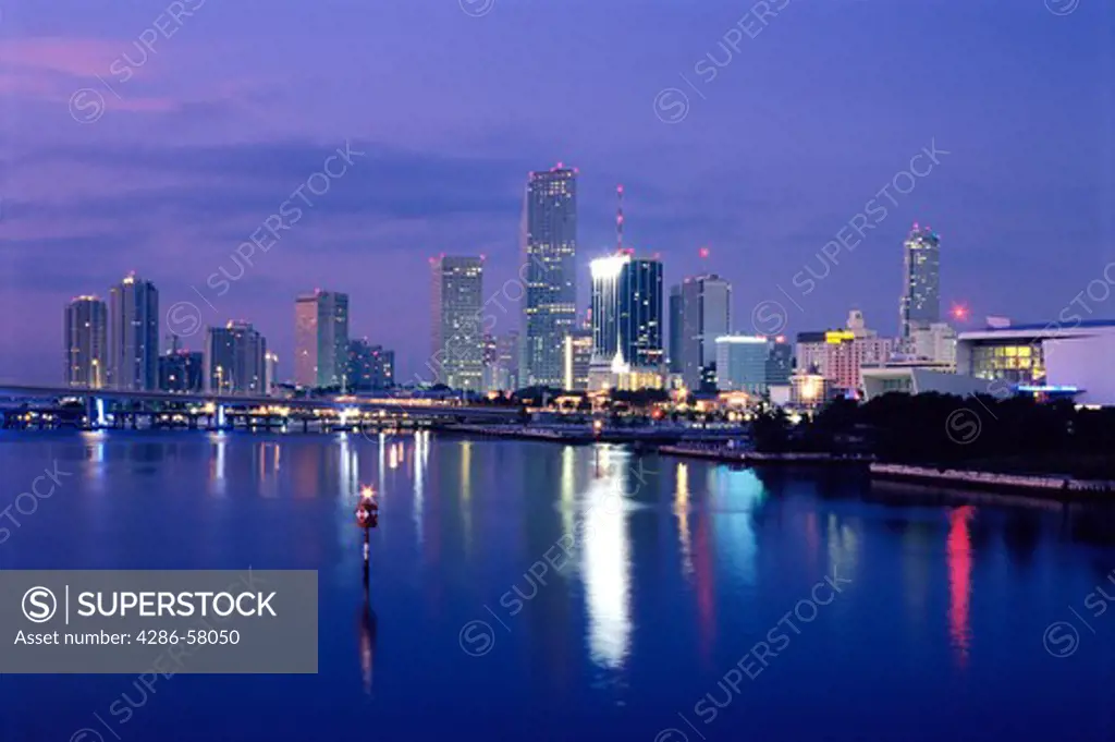 Miami, Florida, skyline reflects in Biscayne Bay at dawn.
