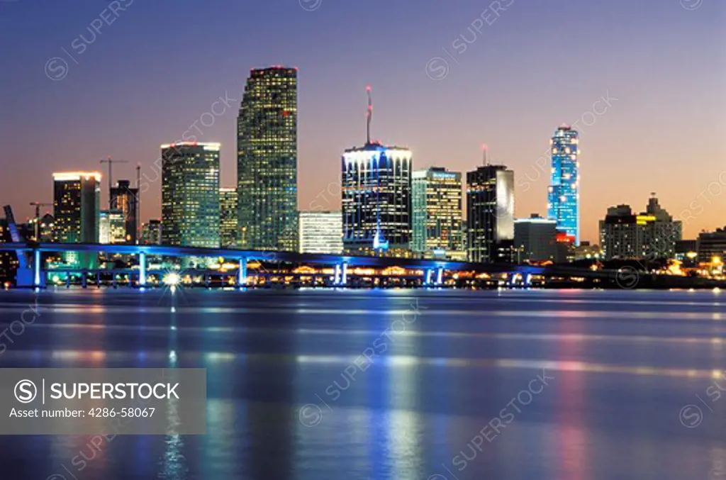 Christmas season snow flakes light downtown Miami, FL, office tower along Biscayne Bay at sunset. 