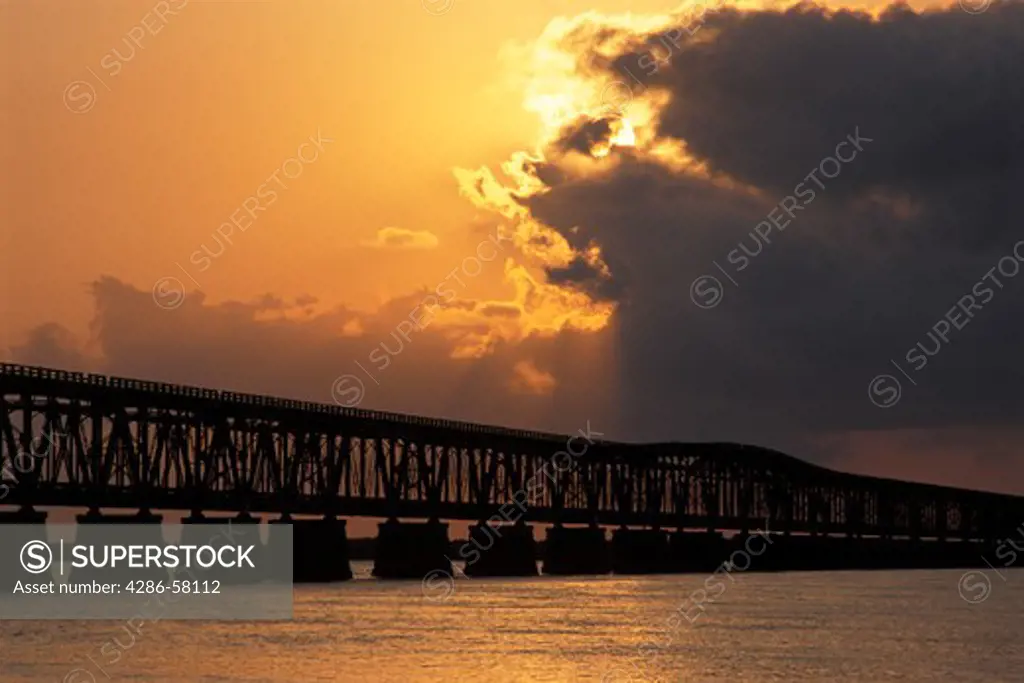 Sun sneaks peak as sets over historic Old Bahia Honda Bridge, Bahia Honda State Park, the Florida Keys, FL