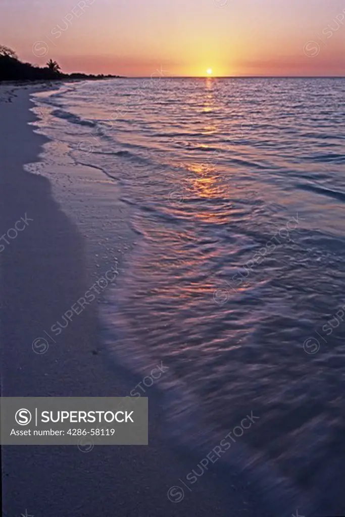 Quiet waves lap island beach as sun rises over ocean, Bahia Honda State Park, Bahia Honda Key, Florida