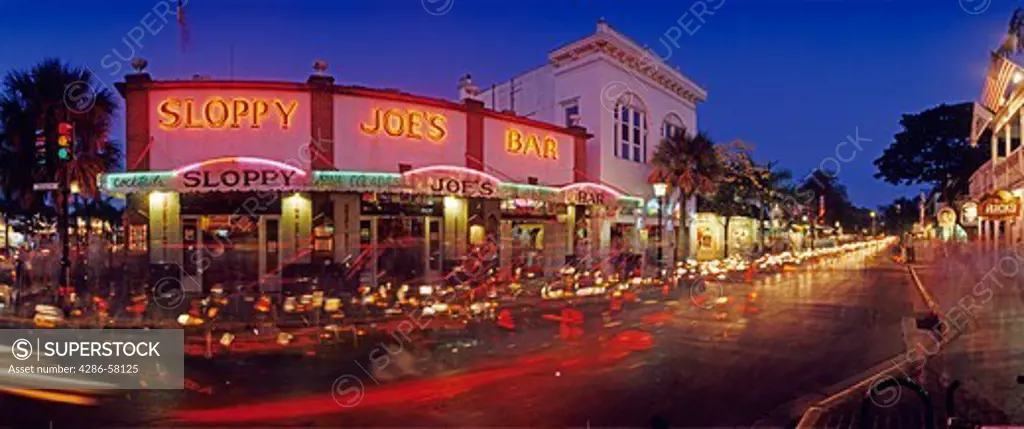 Twilight excitement flows past historic Sloppy Joe's Bar on Duval Street, Key West, Florida.  