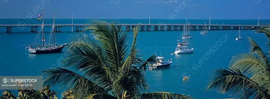 Kyackers paddle among sailing vessels anchored alongside the Overseas Highway, Bahia Honda State Park, the Florida Keys, Florida.