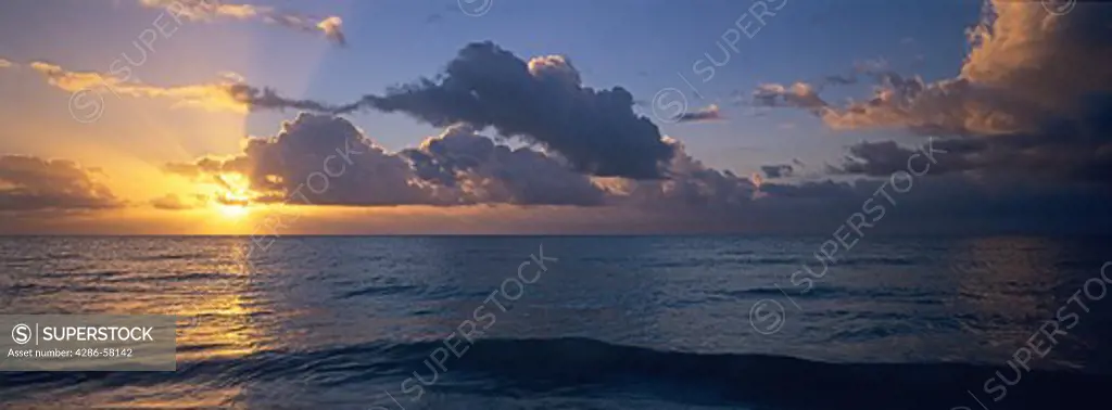 Rising sun breaks through offshore clouds in the Florida Keys, Bahia Honda State Park, Florida.