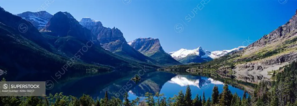 Mirror smooth Lake Saint Mary surrounds Wild Goose Island in Autum, Glacier National Park, Montana