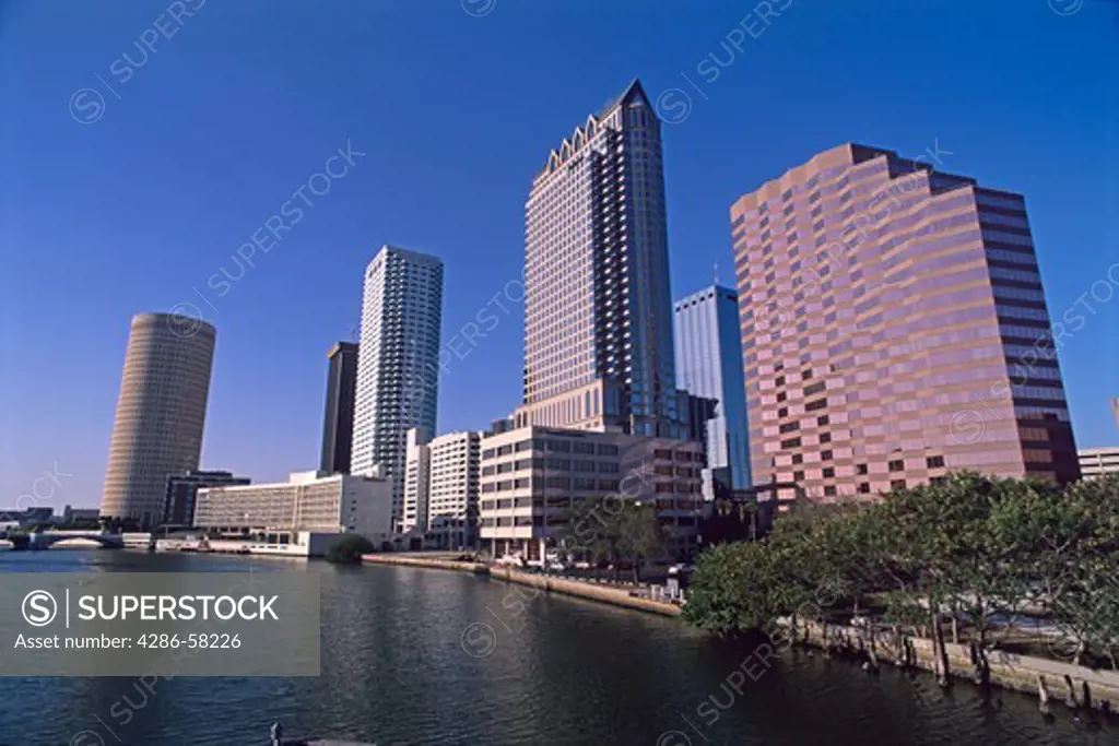 Tampa, FL, skyline towers above Hillsborough River as flows into Hillsborough Bay