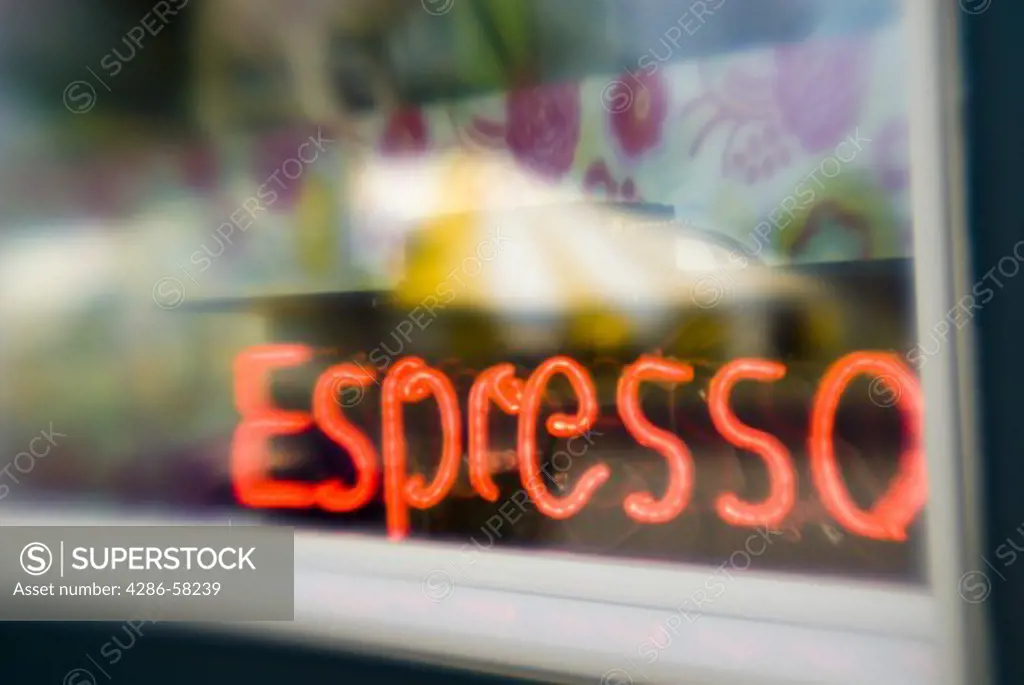 Soft focus lens captures neon sign glowing through cafe window, Otter Tail, Minnesotta.
