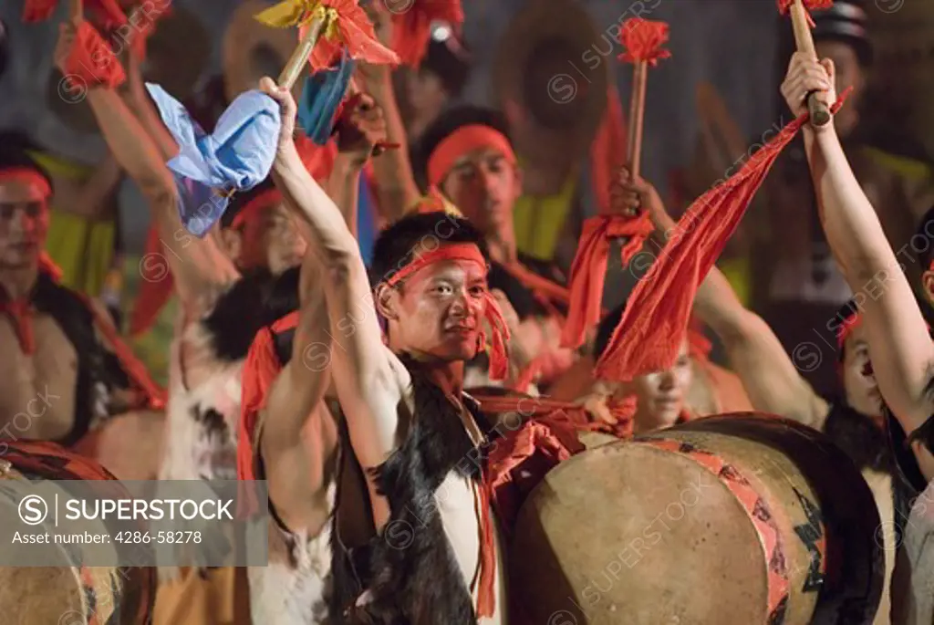 Sani ethnic minority drummers, wearing traditional Charwa or sheepskin vests, at stadium performance that culminates the annual June Torch Festival, Shilin, Yunnan Province, China.