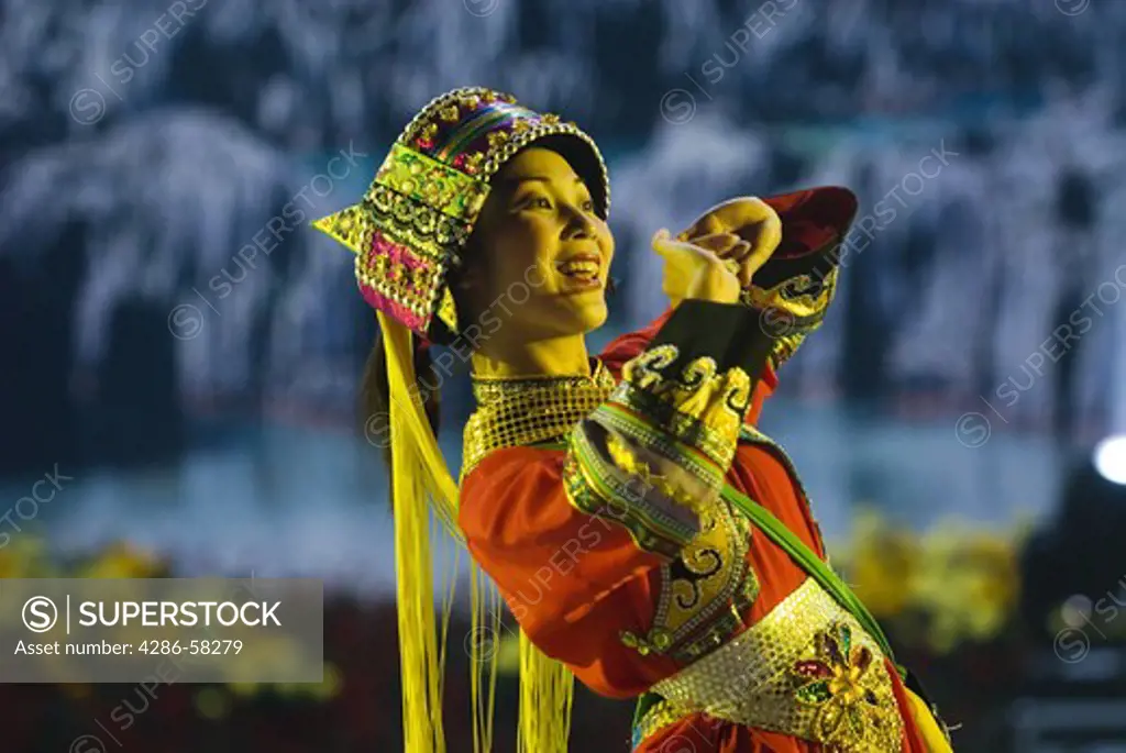 Performer wears costume of the Sani ethnic minority at stadium performance culminating annual Torch Festival, Shilin, Yunnan Province, China.