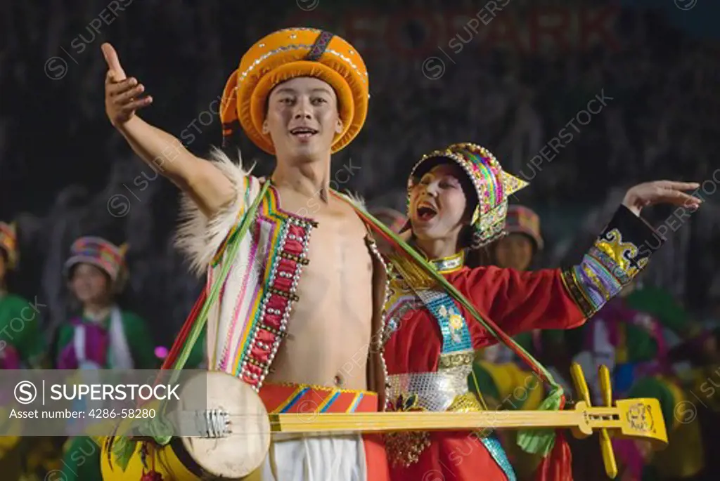Performers wear costumes of the Sani subgroup of Yi ethnic minority at stadium performance that culminates the annual June Torch Festival, Shilin, Yunnan Province, China.