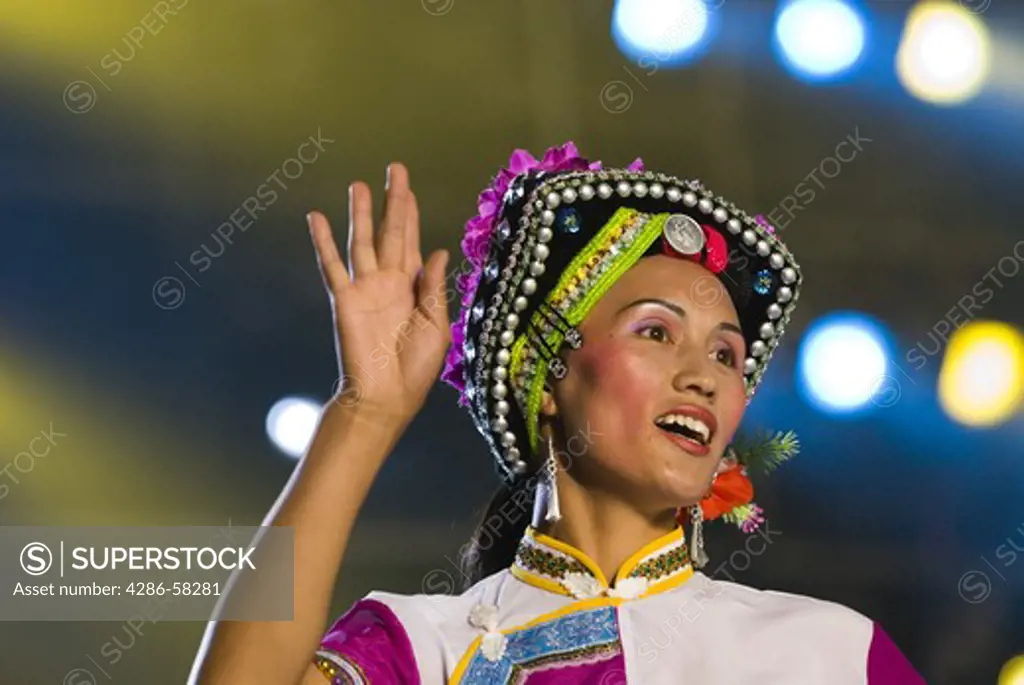 Performer depicts folk stories of Sani ethnic minority at stadium performance culminiting the annual June Torch Festival, Shilin, Yunnan Province, China.
