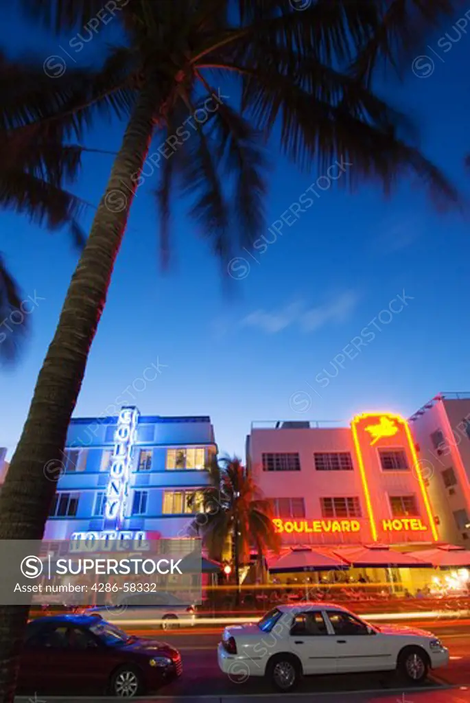 Glowing neon accents art deco era hotels along Ocean Drive at twilight, Miami Beach, Florida.