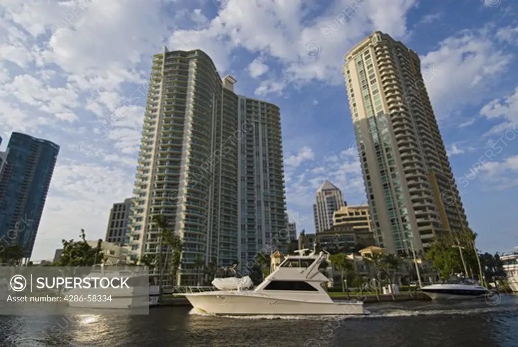 High rise office and condominium towers along the New River in downtown Ft . Lauderdale , FL 