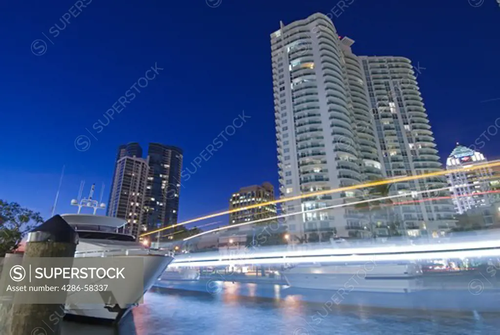 Passing boat blurs along the New River in downtown Ft. Lauderdale, FL, at dusk.