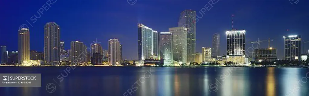  Just before a blue dawn, Biscayne Bay reflects high rise buildings, Miami, Florida.